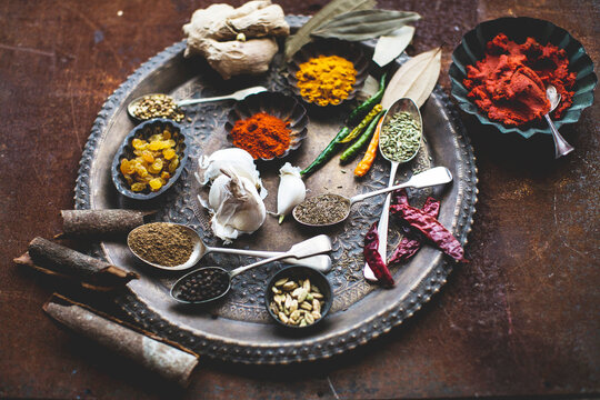 Various spices and sultanas on a metal plate