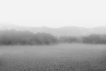 Fototapeta premium Fog in the dam reservoir in black and white