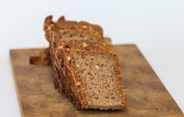 Rye homemade bread on wooden cutting Board on white background