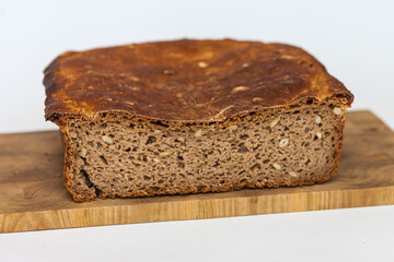 Rye homemade bread on wooden cutting Board on white background