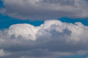 The blue sky is rich in color in clear weather with beautiful lush clouds. The beauty of nature in the fresh air, the layer of atmosphere visible to the eye from bottom to top