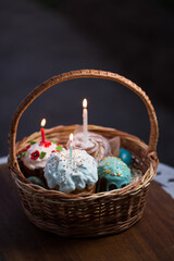 Fototapeta na wymiar slavic russian easter bread kulich pasca in the wicker basket with candles