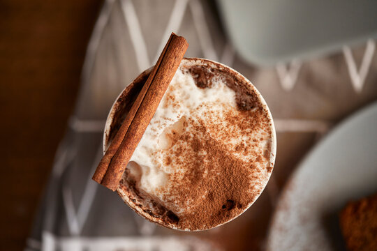 Cappuccino with cocoa and cinnamon stick