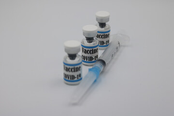 syringe and vials Covid Vaccine on white background with copyspace