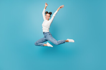 Full length photo of lady jump ballerina pose wear white pullover jeans sneakers isolated blue...