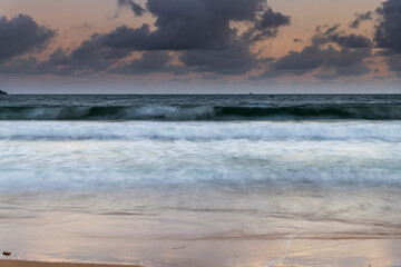 Cloudy sunset seascape with waves