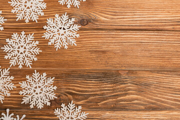 top view of winter snowflakes on wooden 