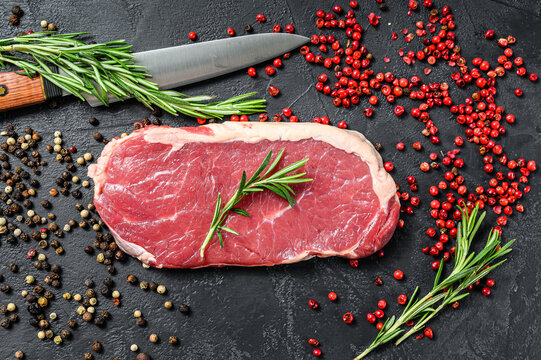 Striploin, Strip Loin Steak Or New York. Raw Beef. Black Background. Top View