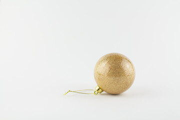 golden ball for christmas tree on white background