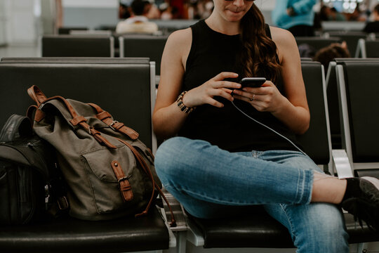 Closeup Shot Of A Lady Using Her Phone While Waiting In A Station