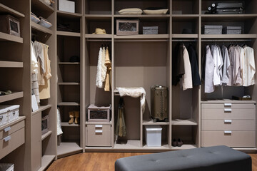 Modern wooden wardrobe with women clothes hanging on rail in walk in closet, Scandinavian style