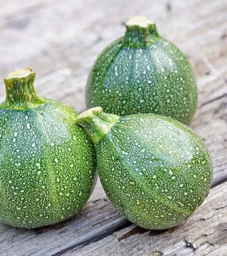 Round zucchini on a wooden background