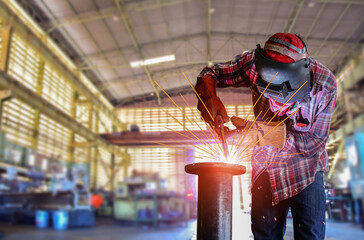 Workers Welding by MIG/MAG Welding gun or Mig welding torch in factory with spark lighe welding with copy space