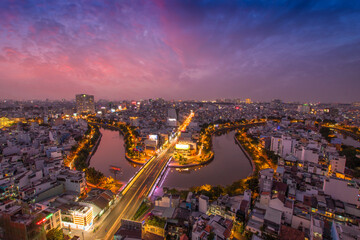 Aerial sunset view of Cau Kieu bridge and houses in Saigon, Vietnam. Business and Administrative Center of Ho Chi Minh city on NHIEU LOC canal.