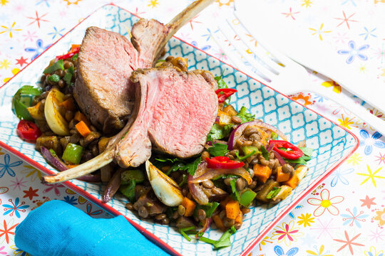 Rare lamb chops on a lentil medley with fresh chillis