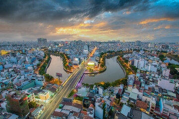 Fototapeta na wymiar Aerial sunset view of Cau Kieu bridge and houses in Saigon, Vietnam. Business and Administrative Center of Ho Chi Minh city on NHIEU LOC canal.
