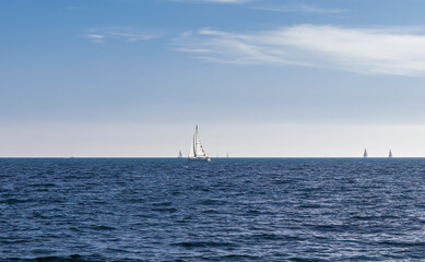 Sailboat yacht in the Mediterranean Sea with a blue sky on the background