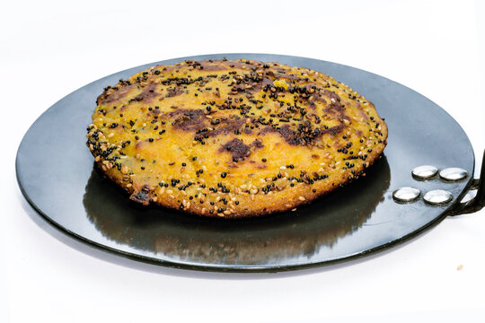 Gujarati Handvo / Handwa Vegetable Cake Gujarati Originating On Nonstick Tawa Isolated White Background