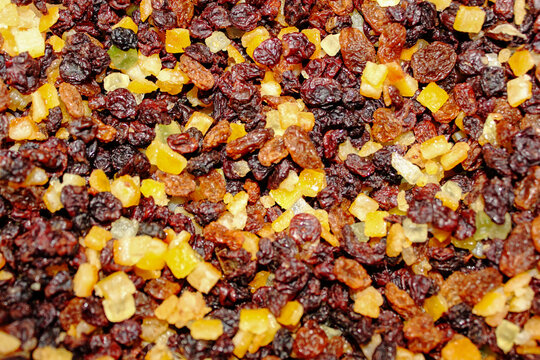 close up of dried  red and yellow raisins, currants, sultanas, mixed orange , lemon and lime peel, and zest, cranberries, and suet . Ingredients for mince meat for pies and Christmas cake.