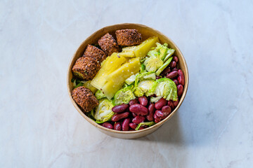 Healthy Food Bowl with Falafel, Pineapple, Mexican Red Kidney Beans and Brussel Sprouts in Plastic Bowl / Box or Container Package.