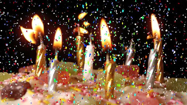 Animation of multi coloured confetti falling over birthday cake with candles