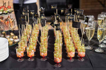 Glasses of fruit and champagne on the table with shallow depth of field