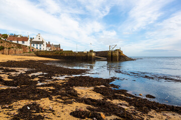 Crail Harbour is completely empty of water at low tide, with the small boats sitting on the sandy bottom. Here, the tide is incoming. There is huge amounts of seaweed on the beach here too.