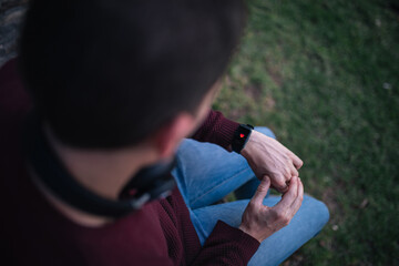 Man with a smart watch, measuring the heart rate. Heart on the smart clock display. Concept of healthy living.