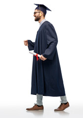 education, graduation and people concept - happy smiling male graduate student in mortar board and...