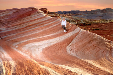 Woman on red rock in Nevada desert.  Valley of Fire. Las Vegas. United States of America 