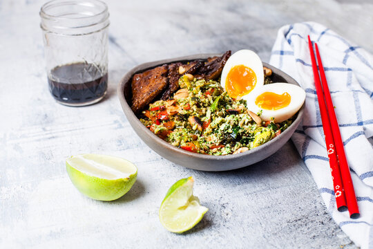 Thai style broccoli 'rice' with spicy dressing, eggs, and beef
