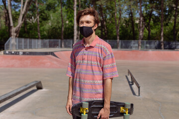 Closeup to the camera amazing man large beautiful smile in a modern skate park holding her...