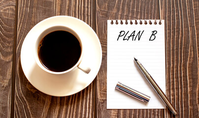 PLAN B - white paper with pen and coffee on wooden background