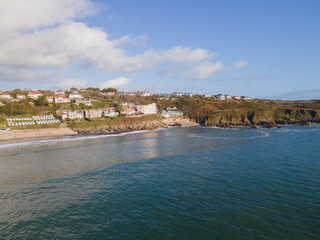 Fototapeta premium Looking Into Langland Bay in Gower, Wales, UK from the sea on a clean late Autumn day. Blue skies with some clouds