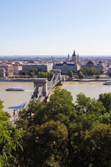 Fototapeta premium The Szechenyi Chain Bridge, River Danube and church St. Stephen's Basilica in Budapest, Hungary. Panoramic view from the famous Fisherman's Bastion on the Pest side. Hungarian landmarks