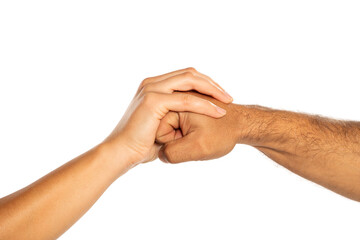 Female hand holding male fist, isolated on white.