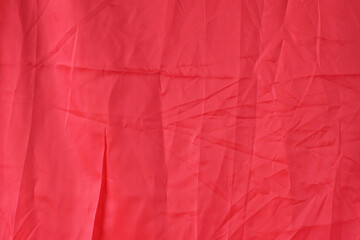 
Rumpled red silk fabric as background.