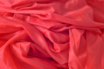 
Rumpled red silk fabric as background.