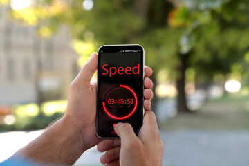 Man using fitness app on smartphone outdoors, closeup