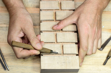 Handmade bricks with a chisel in wood