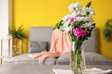 Beautiful bouquet of Chrysanthemum flowers on grey table indoors, space for text. Interior design