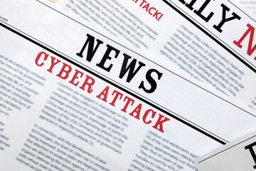 Obraz premium Newspapers with headlines Cyber Attack as background, closeup
