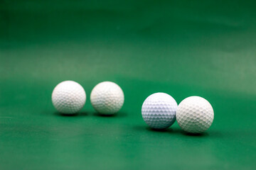 Golf balls are on green background