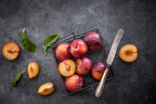 Fresh plums in dark background