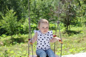 little girl on a swing