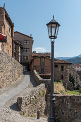 Fototapeta na wymiar Traditional stone-made buildings with cobblestone narrow streets in Potes, Cantabria, Spain