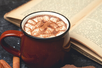 Hot chocolate (cocoa) drink backround. Cocoa drink on a dark background with cinnamon and whipping. Winter hot drinks