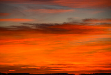 colorful red and orange clouds in the sky right after sunset
