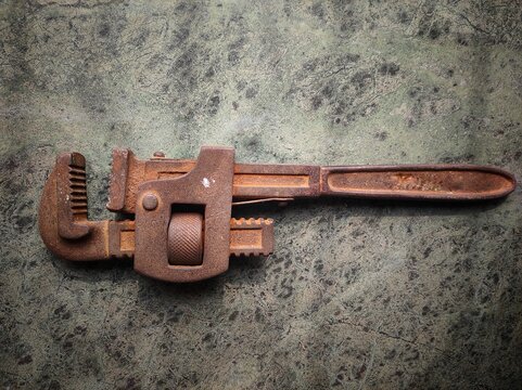 pipe wrench rusted old metal lying on the floor tool equipment