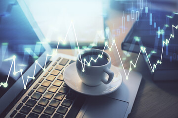 Stock market graph on background with desk and personal computer. Double exposure. Concept of financial analysis.